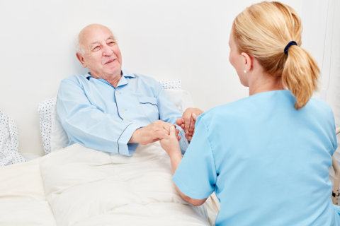 image of an elderly man and her caregiver