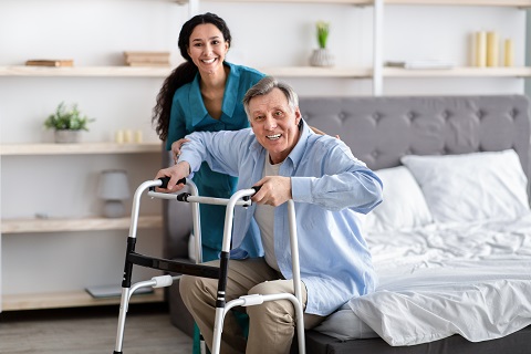 woman caregiver talking to elderly man