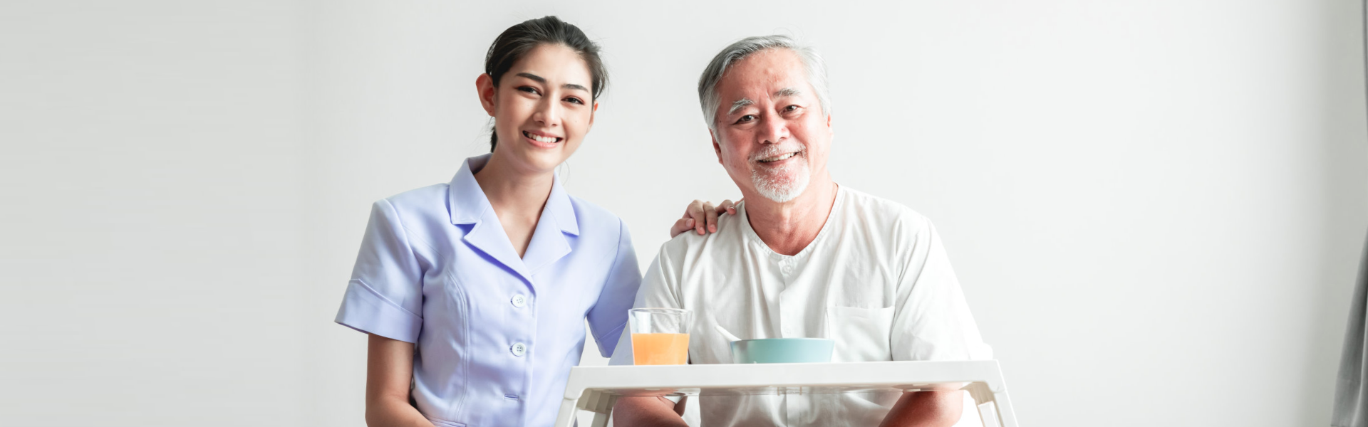 caregiver giving food to the elderly