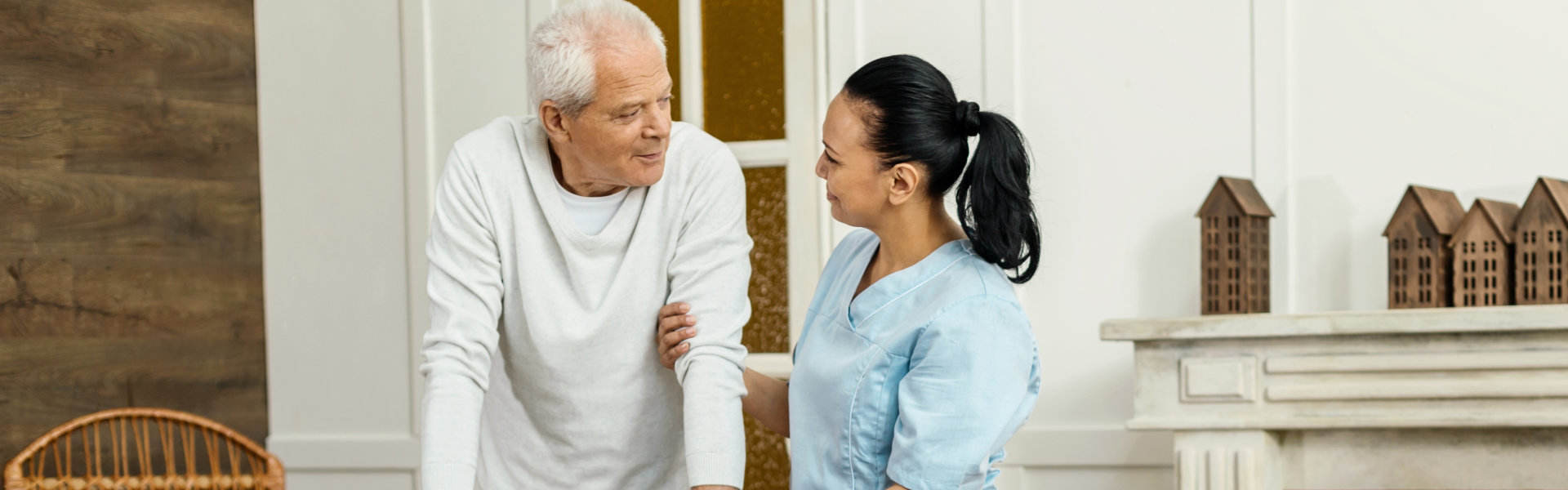 nurse assisting elderly man to walk