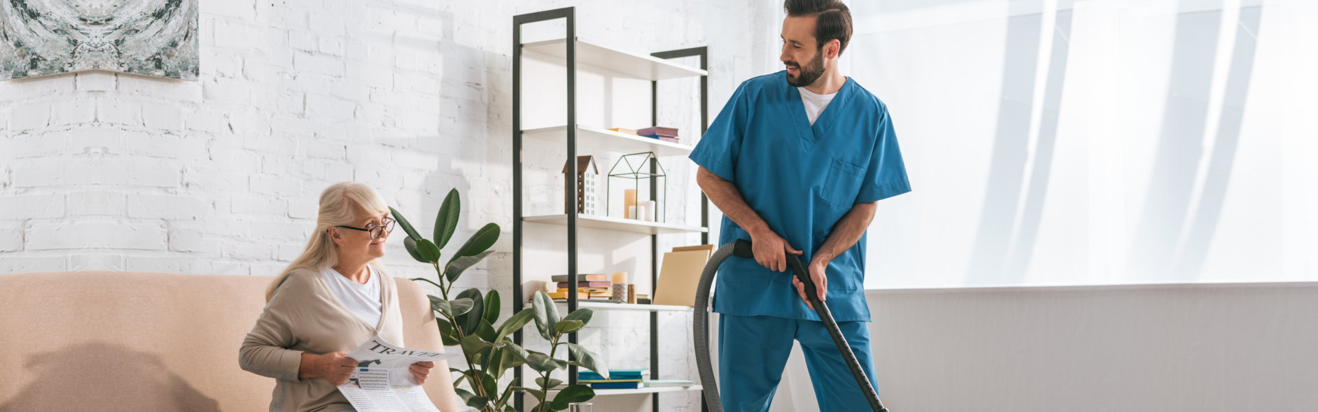 nurse cleaning carpet and a elderly woman sitting