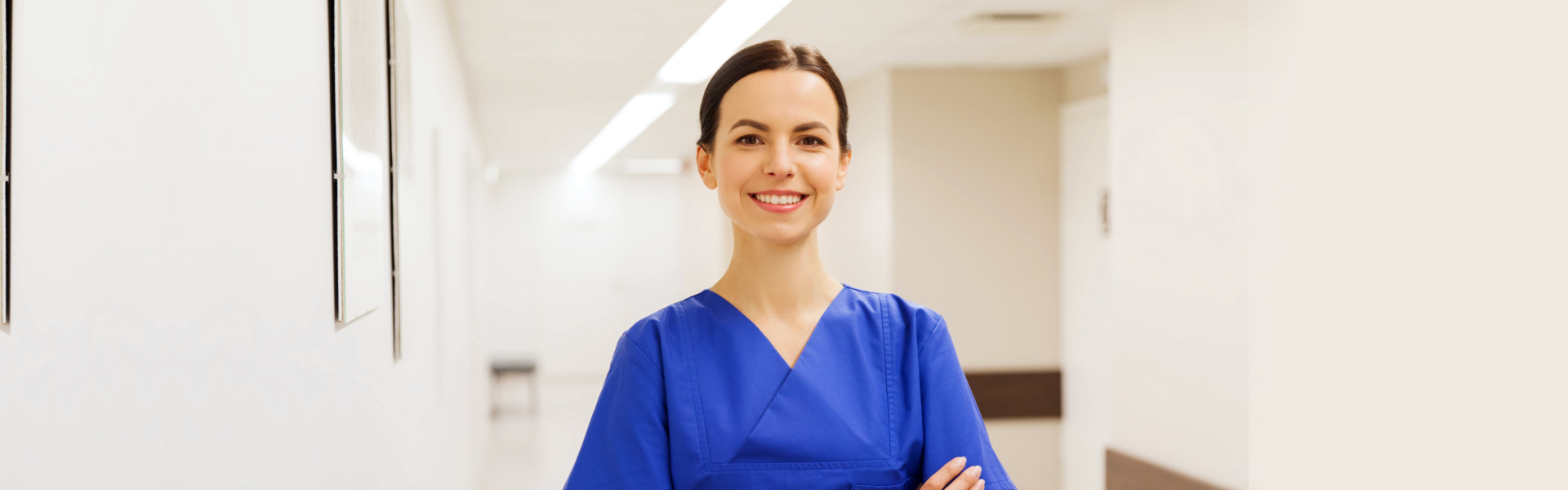 caregiver smiling in the hallway