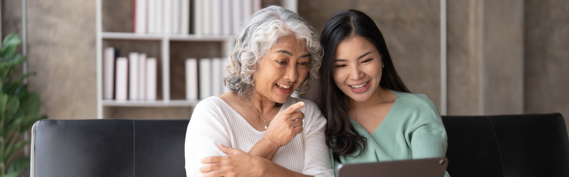 caregiver and elderly watching a movie in the tablet