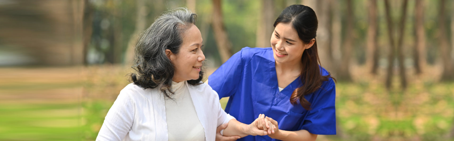 caregiver and elderly walking outside